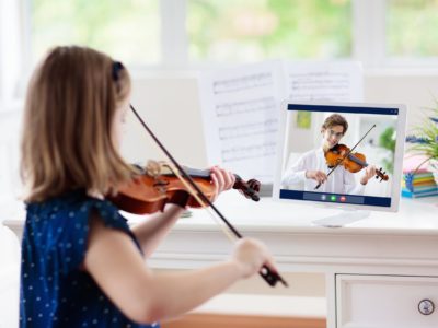 Child playing violin. Remote learning from home. Arts for kid. Little girl with musical instrument. Video chat conference lesson. Online music tuition. Creative children play song. Classical education